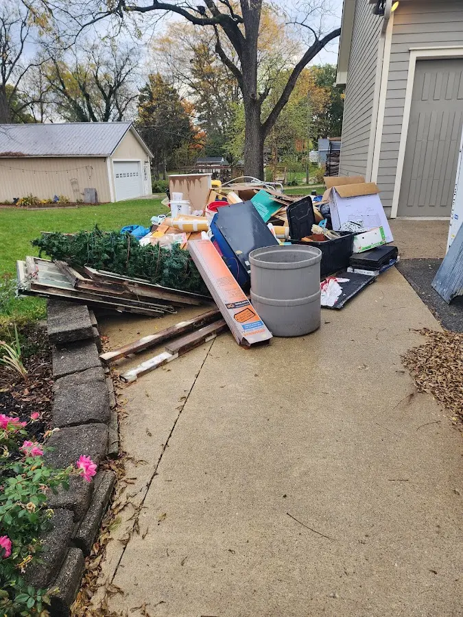 Dumpster being loaded with debris for 12 Yard Dumpster Rental in Lawrenceville
